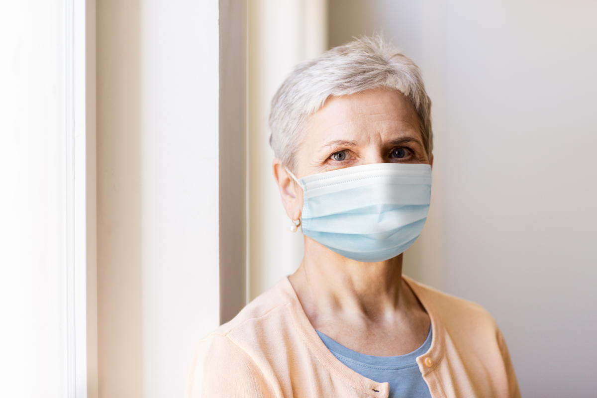 senior woman wears a medical face mask