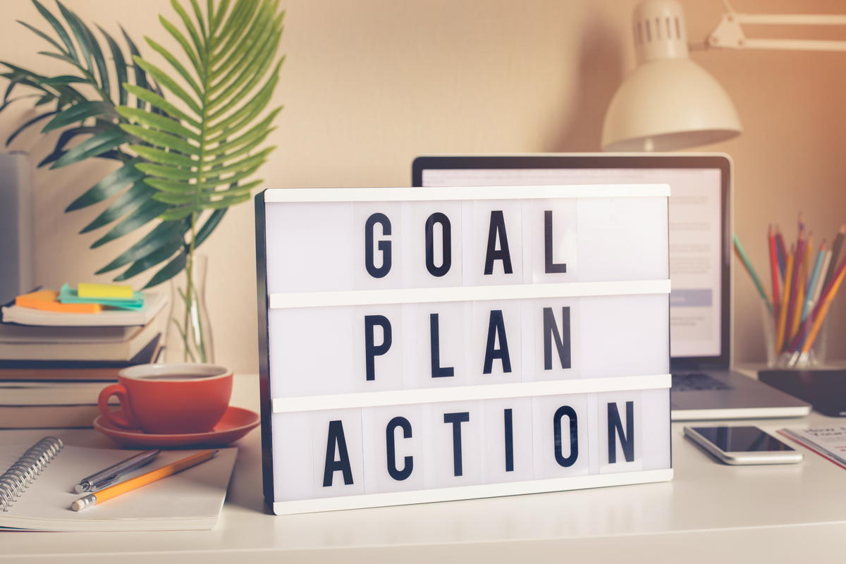 Goal, plan, action text on light box on desk table in home office