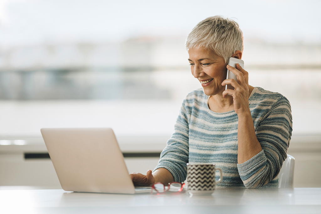 senior calling a business as she reads their email marketing message