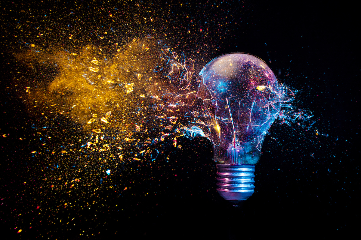 traditional light bulb exploding as concept of disruption