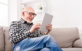 senior man reading email marketing content on his iPad
